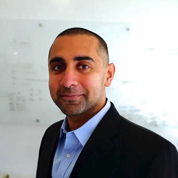 A professional headshot shows a man with short dark hair and a trimmed beard, wearing a dark blazer over a light blue dress shirt, smiling slightly at the camera in what appears to be an office setting with a whiteboard in the background. The image likely depicts Jeff Yew, the Malaysian crypto investor and former Binance Australia head referenced in the accompanying post about his plans to revive Balaji Srinivasan's Network School at Forest City.