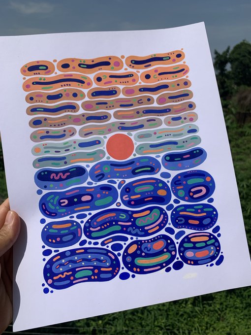 The image shows a hand holding up an art print that features a unique design with various shapes and colors, including blue circles, lines, and dots. The background of the artwork appears to be watercolor or acrylic paint, giving it a vibrant and lively appearance. The text in the image reads "gm + NEW DROP ——————————————————— Before Dark".