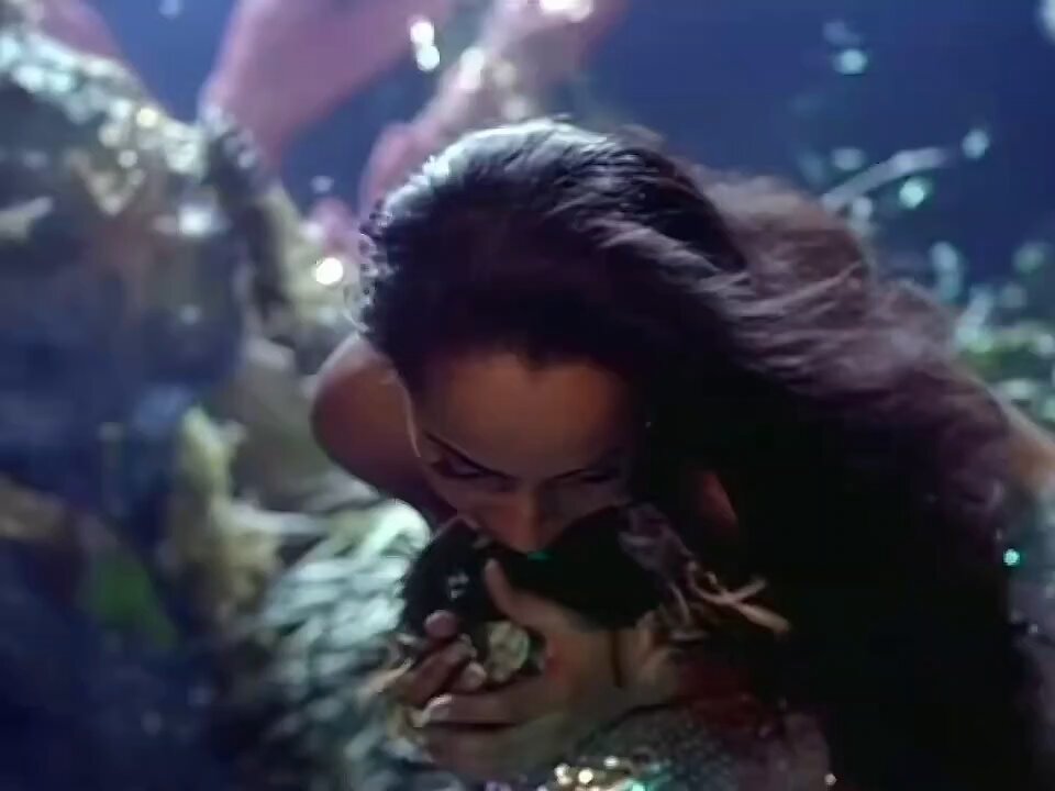 The image features a woman with long hair, possibly wearing earrings or a necklace, who appears to be underwater. She has her mouth open wide as if she's about to take a bite of something. The background shows rocks and plants, creating an underwater scene that complements the woman's appearance. The caption at the bottom of the image reads "I give all my love to bitcoin miners". This phrase is likely a reference to Bitcoin, a digital currency system or cryptocurrency, which has gained significant attention in recent years due to its decentralized nature and potential for anonymity.