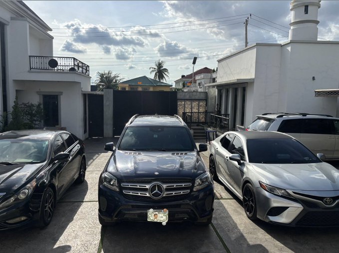 A black Mercedes-Benz SUV is parked in the center of a driveway between a black sedan and a silver Toyota, with the iconic Mercedes star emblem visible on its grille—fitting the "new toy" addition to someone's car collection. The accompanying caption suggests this luxury vehicle purchase is thanks to gains or support from @solana.