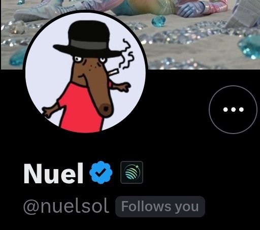 A profile screenshot of a user named 'Nuel' (@nuelsol) with a verified badge, featuring a cartoon goat in a black hat and red shirt smoking a cigarette, with a shell and gem background.