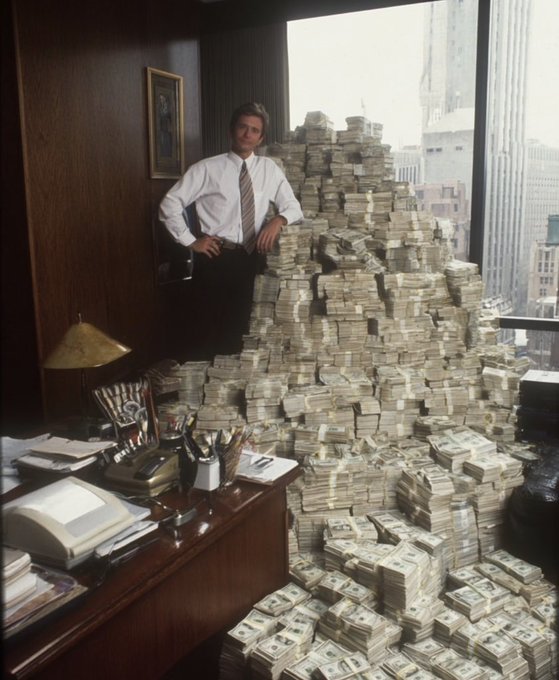 A famous photograph of a young man in a white shirt and tie leaning against an enormous pyramid-shaped pile of bundled US dollar cash stacked high in a wood-paneled office.