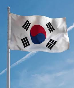 The South Korean flag waves against a blue sky, symbolizing the Korean market mentioned in the post about Ki Young Ju's observation that this Bitcoin bull cycle will be driven by foreign capital due to Korea's lack of a spot Bitcoin ETF and restrictions preventing retail and corporate investment in foreign crypto products.