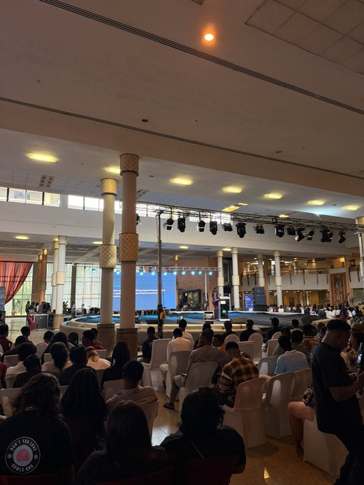 Attendees gather in rows of white chairs facing a brightly lit stage featuring the Solana logo and event signage at the Solana Summit Nigeria 2026, with "PAUL BLAY" partially visible on the screen behind the speaker.