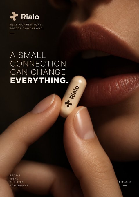 An advertisement for Rialo featuring a close-up of a person holding a white pill imprinted with the Rialo logo near their lips, with the tagline 'A SMALL CONNECTION CAN CHANGE EVERYTHING.' and 'RIALO.IO' visible.