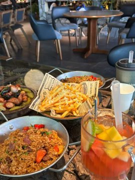 The image shows a table with various food items, including fried rice, french fries, and other dishes. There are also drinks such as soda and juice available for consumption. The focus of the image is on the food and beverages displayed on the table, which could be related to the post about Bitcoin or cryptocurrency.