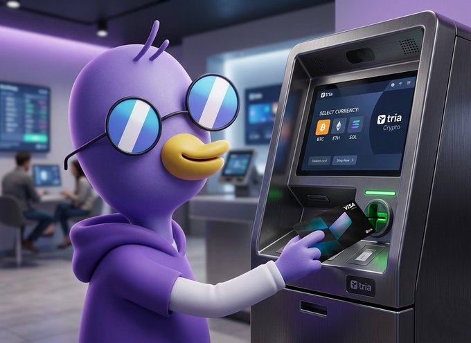 The image features a cartoon duck wearing glasses, standing next to an ATM machine with its hand extended towards the screen. The ATM machine displays a message about using the "Glad I can wake up and use my @useTria card for mine morning coffee." This suggests that the ATM is promoting the use of the Tria Card as a convenient way to access cash, possibly in exchange for cryptocurrency.