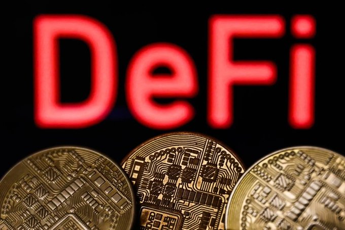 Three gold Bitcoin coins are displayed against a black background with the word 'DeFi' in glowing red letters.