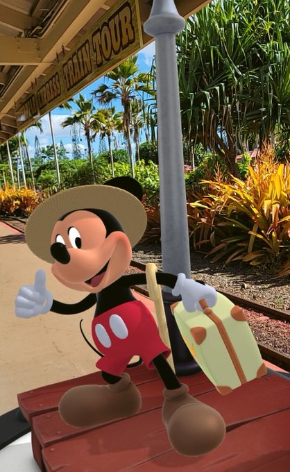 Mickey Mouse, dressed in a safari hat and holding a suitcase, stands on a platform beneath a "Walt Disney's Train Tour" sign at what appears to be a Disney theme park, fittingly capturing the travel-themed VeVe community connection request from Hawaii.