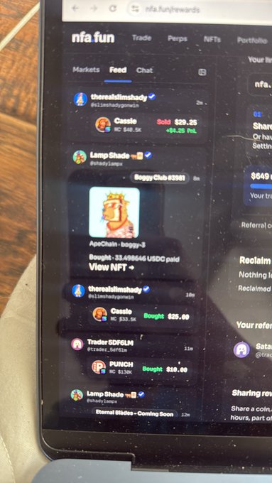 A smartphone displaying the nfa.fun website, showing an "nfa fun" feed with recent transactions like "Cassie" being sold for 25.35 and "Boggy Club #3361".
