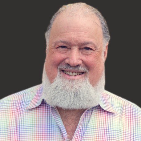 A cheerful older man with a full white beard and receding hairline, wearing a pastel checkered shirt, smiles warmly against a black background. The image accompanies a post introducing David Chaum, often regarded as the "Godfather of cryptocurrency" for his pioneering work on Digicash, eCash, and the Elixxir and Praxxis networks.