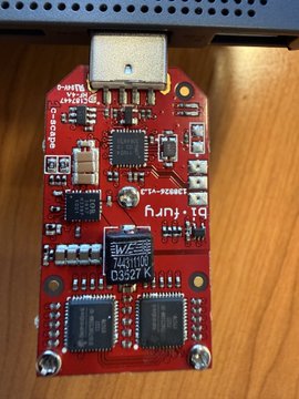 A close-up of a red USB device with visible circuitry chips, labeled 'Dash Plug' with various component markings.