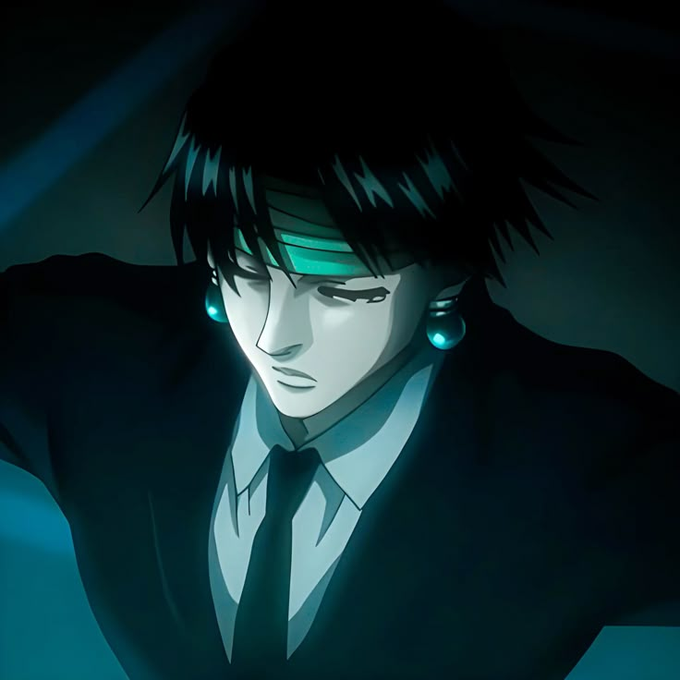 The image features a man wearing a suit, tie, and earrings with blue lights. He has dark hair and looks sad or thoughtful as he gazes downwards. The accompanying text reads "Gm Drop $SOL wallets." This suggests that there might be some sort of wallet-related product featured in the post.