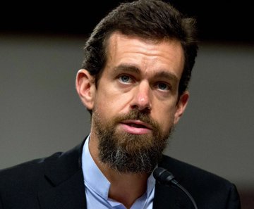 The image features a man with a beard wearing a suit, standing behind a microphone while speaking into it. The caption of the image reads "I think @jack one day will probably look at #Dogecoin and realize it will make the current financial system feel as irrelevant as the fax machine". This statement is likely related to the ongoing conversation about the impact of cryptocurrencies like Dogecoin on traditional financial systems, given that the man in the image seems to be discussing this topic.

The caption also mentions a "Dogecoin", which could potentially be a reference to Bitcoin or another cryptocurrency. The presence of the microphone suggests that the man is addressing an audience and possibly sharing his thoughts about the future of money and technology.
