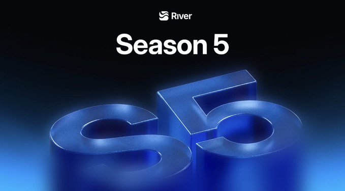 The image features a large blue block with the number "S5" written on it. The background of the image is black, which contrasts with the blue block. The text "Season 5" is also present in the image. The overall layout suggests that this could be an advertisement or promotional material for a show or event related to the #RiverdotInc brand.