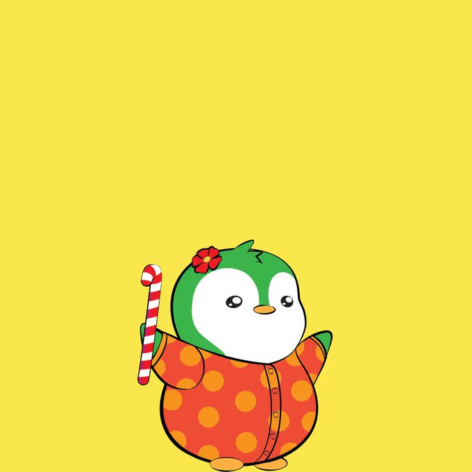 A cartoon penguin mascot with a red flower on its head, wearing an orange polka-dot shirt and holding a red and white candy cane against a yellow background.