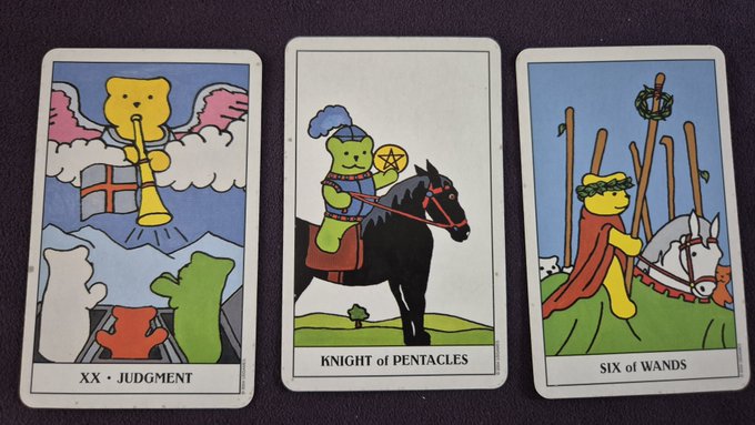 Three tarot cards displayed on a dark surface: XX Judgment, Knight of Pentacles, and Six of Wands, all featuring colorful cartoon bear characters in place of traditional imagery.