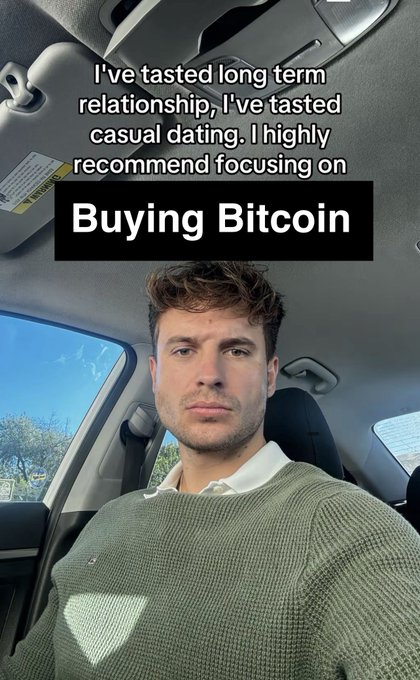 A man in a green sweater sitting in a car with text overlay reading 'I've tasted long term relationship, I've tasted casual dating. I highly recommend focusing on Buying Bitcoin'.