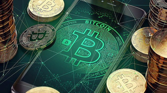 A digital composition featuring physical Bitcoin coins stacked around a smartphone displaying a glowing green Bitcoin logo with a network overlay graphic.