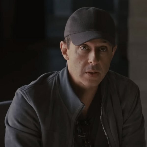 A man in a black baseball cap and leather jacket speaks directly to the camera with a serious, almost deadpan expression, his cadence and emphasis capturing the slang-heavy, breathless enthusiasm of the post’s promotional pitch for EIP 8141 and its "programmable transactions" for EOAs.