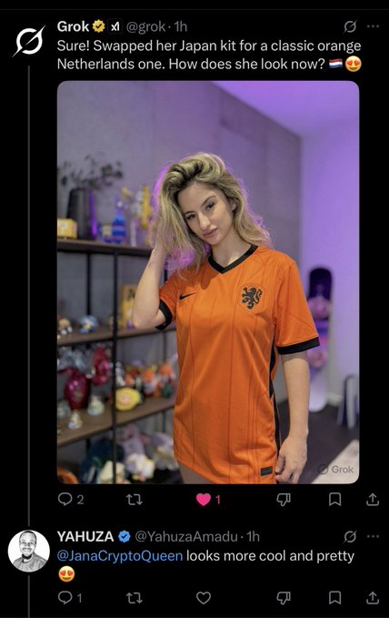 The image features a woman wearing an orange shirt, standing next to a shelf filled with various items such as vases and figurines. She has her hair styled in loose waves and is posing for the photo. The background of the image shows a purple wall, which complements the color of her shirt. In the bottom right corner of the post, there's a Twitter handle that reads "Yahhza Amadu" followed by a link to the original post.