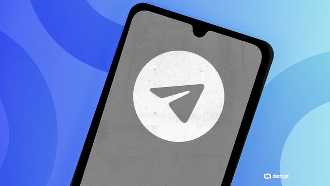 A smartphone displaying the Telegram paper airplane logo on a gray screen with a blue abstract background, branded with the Decrypt watermark.