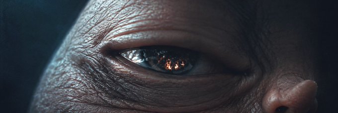 A close-up of an eye reflecting a fiery orange glow, surrounded by weathered, dark, textured skin. The dramatic, burning reflection in the iris evokes a sense of intensity that complements the newly added Solana token ($Qenis) banner image on Moby.