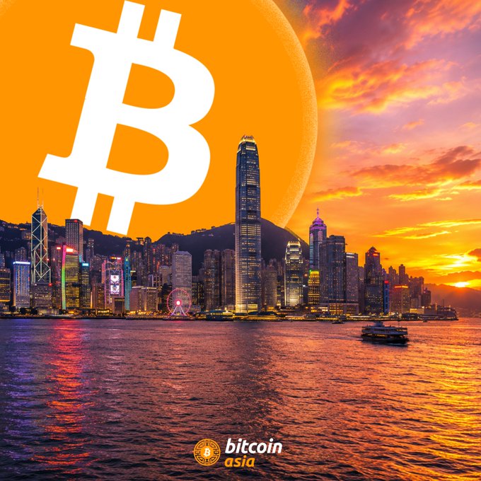 In the image, there are two scenes set against the backdrop of Hong Kong's skyline. The cityscape features tall buildings with a mix of colors, including reds, oranges, and yellows from the setting sun reflecting off the water surface. Below this captivating view, the words "Bittecoin Asia" can be seen in the image. A Bitcoin logo is prominently displayed at the top left corner, indicating its prominence within Hong Kong's digital currency scene. The Bitcoin logo says "HONG KONGPUBLIC COMPANIES now hold roughly $425M worth over $425M". These two scenes together create an intriguing juxtaposition of technology and urban development in the world's largest financial center.