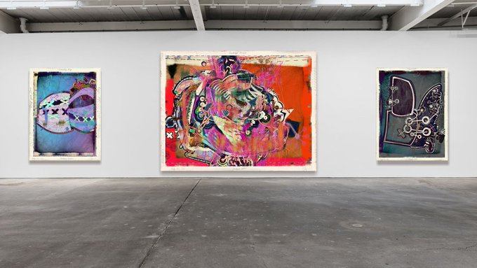 Three large, colorful abstract expressionist paintings displayed on a white gallery wall in a spacious industrial-style art gallery with concrete floors.