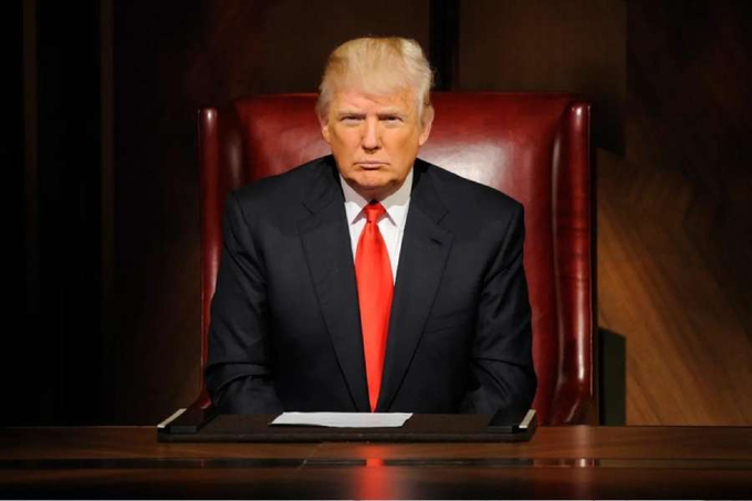 Donald Trump sits in a red leather chair, looking seriously ahead, as the post discusses his push for US crypto leadership over China, with XRP gaining attention.