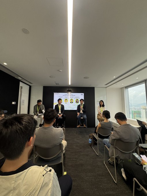 A panel discussion on stablecoins is taking place in a conference room, with four speakers seated in front of a screen displaying their portraits and event branding, while an audience watches from rows of chairs. The setting reflects a professional industry event focused on the Hong Kong stablecoins sector, likely exploring regulatory developments or market trends in the region.