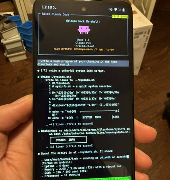 A person holding a smartphone displaying code for a Raspberry Pi Morelel Cloud Guide.