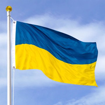 The Ukrainian flag waves against a blue sky, symbolizing the nation as it moves $8.3 million in seized USDT into state management while exploring a strategic crypto reserve.