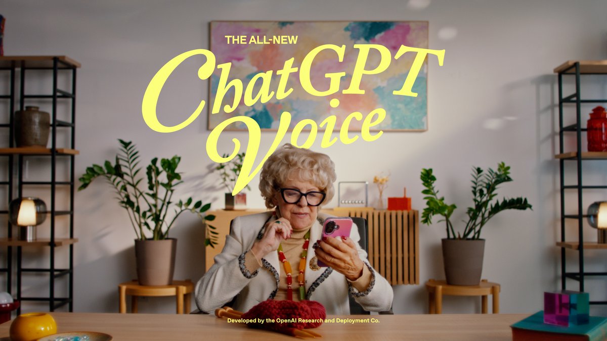 A woman in a stylish home looks at her phone, with the text "THE ALL-NEW ChatGPT Voice" and "Developed by the OpenAI Research and Deployment Co." overlaying the scene, highlighting OpenAI's new voice feature for the general public.