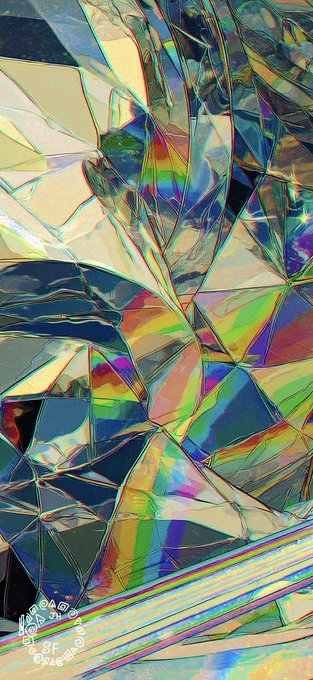 A close-up image showing light refracting through shattered or textured glass, creating a prismatic pattern of iridescent rainbow colors.