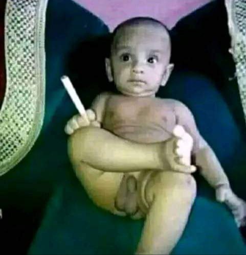 The image displays a baby sitting in a chair, holding a white object and its foot, which relates to the text "SOL Pumping 2%" and "someone's situation right now" concerning $SOL.
