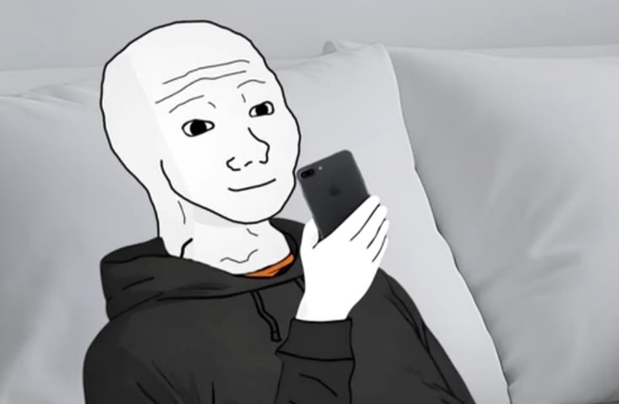 The Wojak meme character (a simple black-and-white cartoon figure) lying in bed wearing a black hoodie while looking at a smartphone.