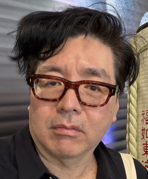 The image features a man wearing glasses, with his face partially obscured by them. He appears to be looking directly at the camera, possibly posing for a photo or selfie. The background of the image includes text that reads "Tom Lee says crypto is the only path to tokenization and the machine-to-machine AI economy. I actually agree ... $ETH still settles more value than any other smart contract chain. Real volume. Real revenue. Real builders." This text seems unrelated to the main subject, which is the man wearing glasses in front of a camera.