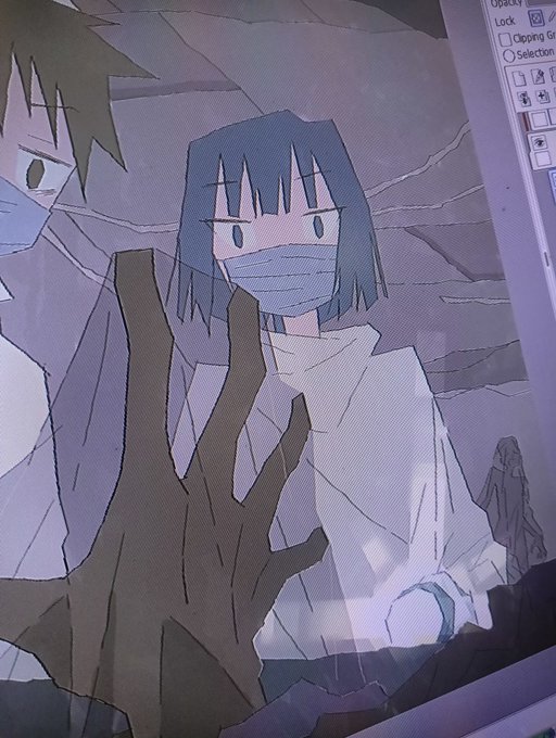 A photograph of a computer screen showing digital artwork of two anime-style characters, one with a brown hand raised in the foreground and another with dark hair wearing a face mask and white robe.