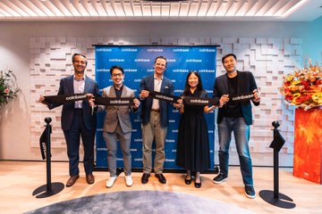 A group photo of five people in business attire holding black plaques at what appears to be a corporate or partnership event.