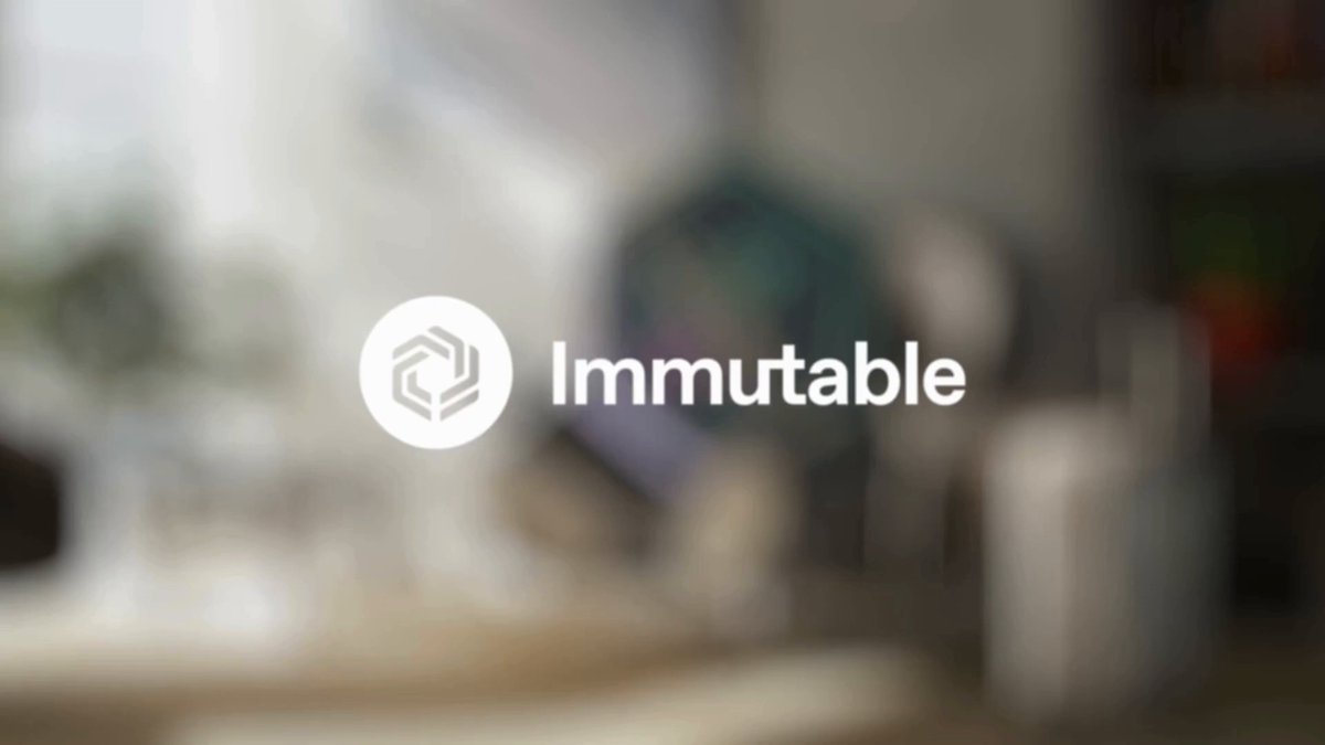 The image features a logo that reads "immutable" with a white hexagon shape above it, which is a common design element used by companies to represent their brand identity. The text below the logo states "immutable" as well as "immutables", indicating that this company specializes in creating immutability for various aspects of gaming and digital content. The image also includes an image of a chair with a suitcase on it, which could be related to the gaming industry or simply serve as a decorative element within the room where the logo is displayed.