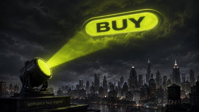 A spotlight illuminates a "BUY" button in the sky over a Gotham-style cityscape, labeled "gotham's buy signal" at the base. The image humorously visualizes the post's message about the return of Robinhood's iconic buy button, framed as a long-awaited, history-making signal flashing above a dark financial skyline.