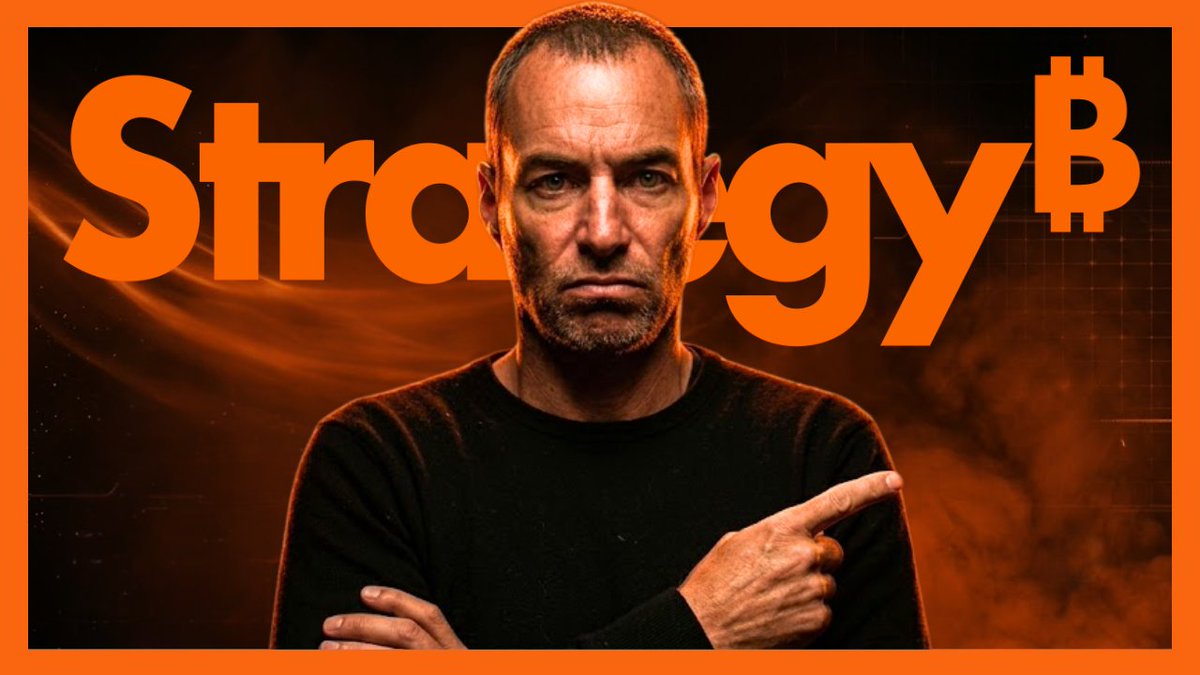 A serious-looking man in a black shirt points to the right, set against a fiery orange background with the word "Strategy" and a Bitcoin symbol (₿) in bold orange text behind him, reinforcing the post's warning about Strategy stock's 84% decline and the $74 STRC price level.