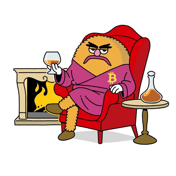 A cartoon illustration of a grumpy orange furry character in a pink robe with a '₿' Bitcoin logo, sitting in a red armchair holding a glass of cognac next to a fireplace.