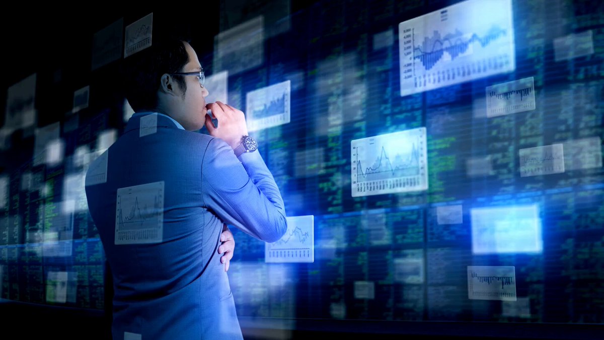The image features a man dressed in a business suit looking at a display screen filled with charts and graphs related to blockchain technology. The background appears to be black with various lines or patterns scattered throughout, giving the impression that they are connected to different data points on the screen. The main focus is the man's interest in the digital information before him, suggesting his engagement with an AI-native blockchain ecosystem.