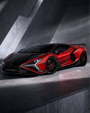 A red and black Lamborghini sports car parked in a modern concrete setting with dramatic lighting.
