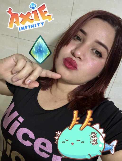A woman with red hair posing next to the 'Axie Infinity' logo, an in-game gemstone, and a cute blue Axolotl character graphic.