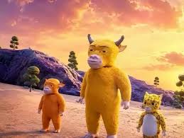 3D animated characters resembling a large yellow horned creature flanked by a smaller orange monkey and a leopard-print cub, standing in a stylized landscape.