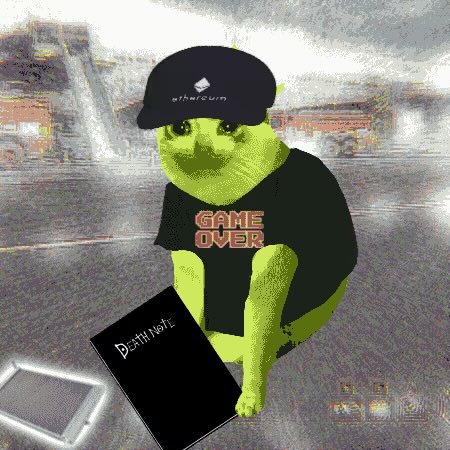 A digitally edited image shows a green cat in a black 'GAME OVER' t-shirt and cap, sitting with a black notebook labeled 'Death Note' in an urban street setting.
