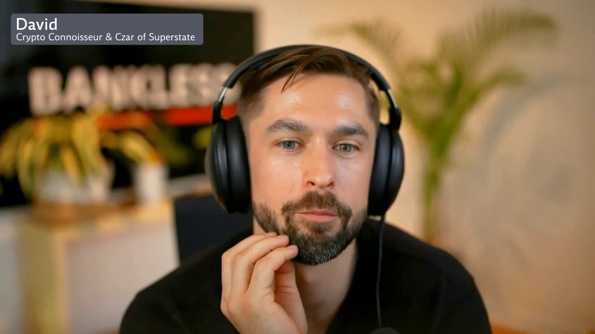 The image features a man wearing headphones with his hand resting on his chin while sitting at a desk or table. The background includes a potted plant and a sign that reads "Bankless". A caption below the image states, "You can see Vitalik writing an article saying 'I'm not in charge anymore' and then everyone' s like 'Oh my God, such a great article I can't wait for Vitalik to write something next.'" The man's position at the desk suggests that he is engaged in some work or activity related to the post.